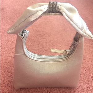 Silver clutch with bow on top.  NWT